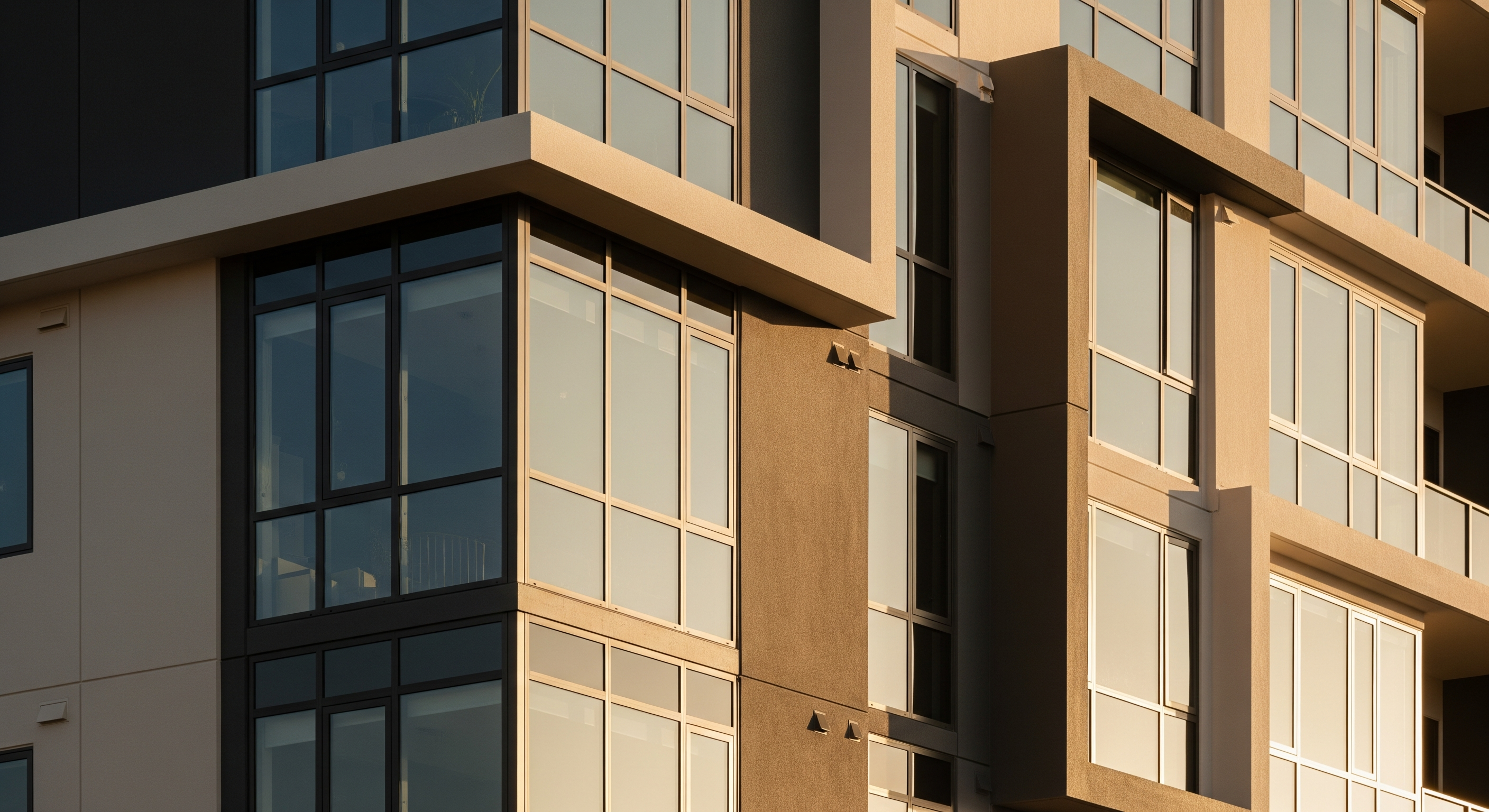 Close-up of a modern apartment building façade with large grid-style windows.